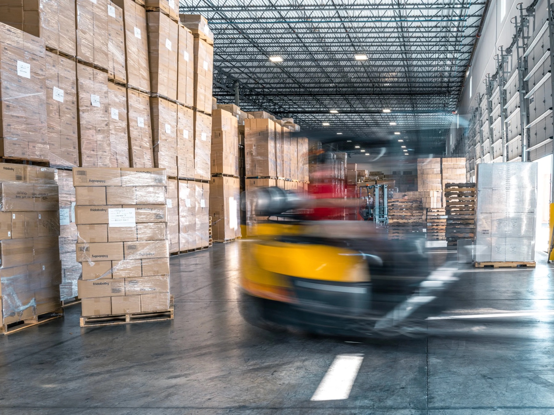 Forklift moving freight inside a NOAMEX warehouse
